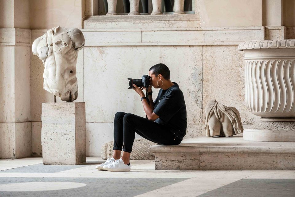 an image of the artist taking photos in a museum gallery